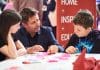 New skills hub and recruitment zone unveiled for UKCW London 2024 George Clarke at UKCW skills hub with children