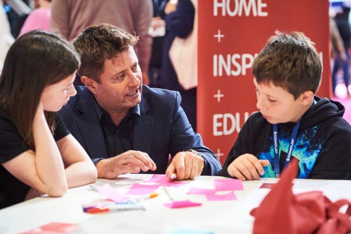 George Clarke at UKCW skills hub with children