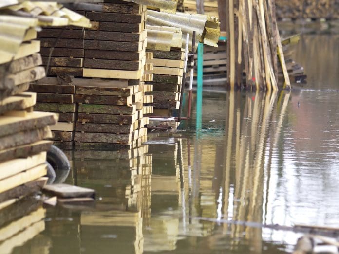 Tysers Insurance Brokers negotiates better settlement for underinsured policyholder Flooded Timber Storage in Laze village near Logatec, during a great flood as a result of icy embrace during frost in winter 2014, Slovenia, Europe. This is part of the Karsts region with Planinsko highland which is occasionally Lake too. On some placesit is more than 8 m of water.