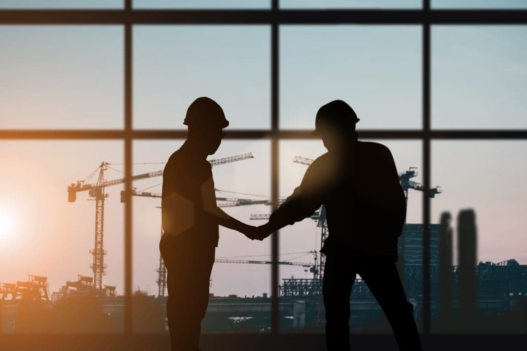 Silhouette of engineer and construction team working at site over blurred background for industry background with Light fair.Create from multiple reference images together, representing construction workforce development
