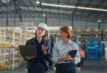 UKAS operations director explores how accreditation enables seamless supply chains Young caucasian woman worker and mature female manager walking checks stock inventory with tablet and laptop and discuss talk together in retail warehouse. Logistic industry business concept.