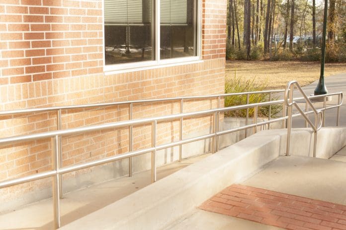Wheelchair ramp at a business office or school campus. No people.