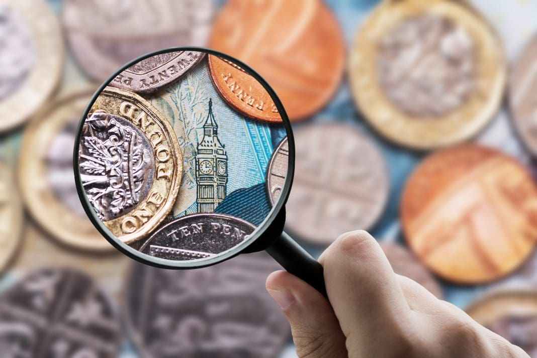 Magnifying glass focusing Great Britain Pound (GBP) currency Chancellor Jeremy Hunt has delivered the Spring Budget for 2024, delivering promised tax cuts- and not much else