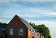 What are the challenges faced in meeting The Future Homes Standard? Row of new built houses in england uk, representing the Future Homes Standard