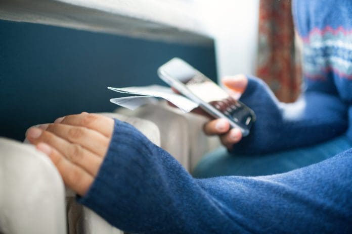 Man trying to warm up near a heater Man's cold hands in warm sweater on radiator in winter. Energy crisis concept representing Energy service contracts