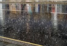 Heavy rainfall blamed as UK construction output dips 1.9% in February Torrential rain hitting the tarmac of a street in London.