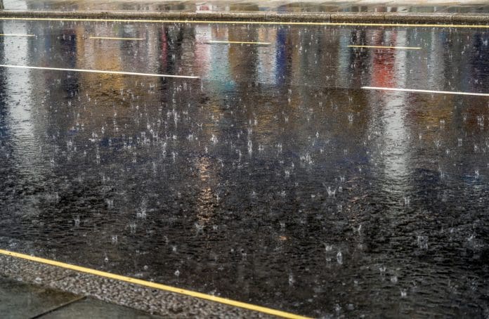 Heavy rainfall blamed as UK construction output dips 1.9% in February Torrential rain hitting the tarmac of a street in London.