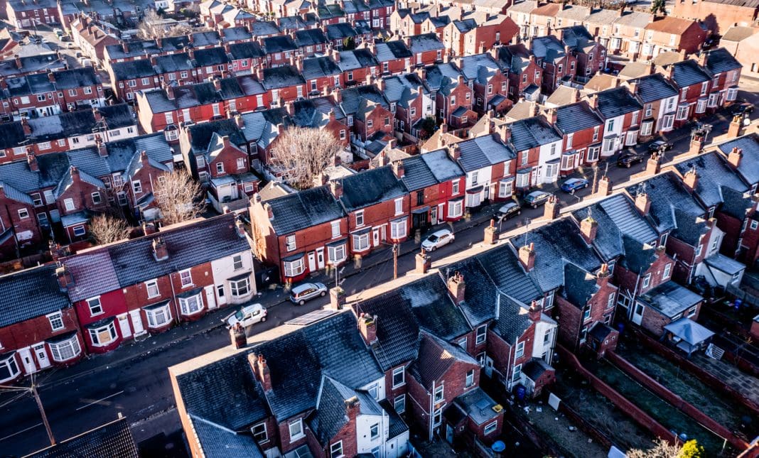 Aerial view of a row of terraced or back to back working class houses during the Winter months with frost on rooftops during the energy and cost of living crisis