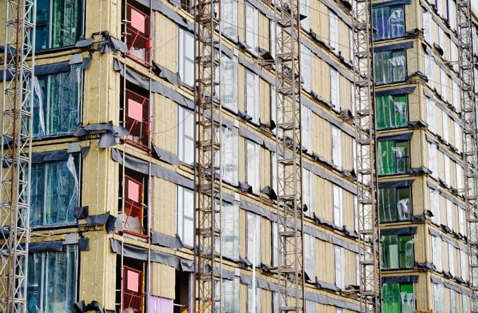 Government review suggests new agency for building remediation High rise residential building of flats with cladding being replaced with fire resistant materials UK