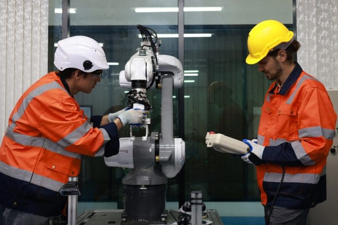 How Britain’s construction sector could benefit from using robotics Two engineers check and control the welding robotics automatic arm machines in an intelligent factory that produces auto parts.