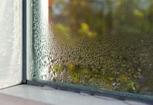 Combatting damp, mould, and condensation for healthier homes window with water drops closeup, frame inside, selective focus, damp
