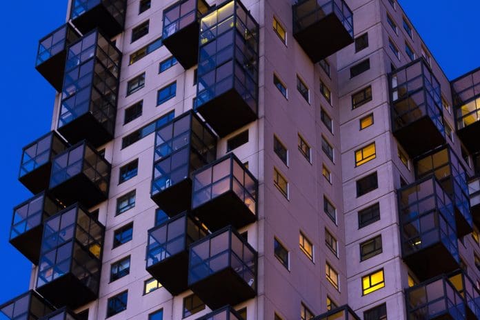 Legal and compliance implications of the Building Safety Act Late night view of council flats. Exterior of complex building in the city