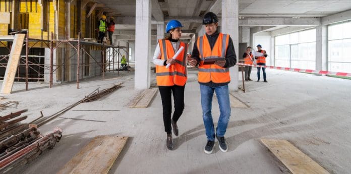 Construction Foreman Explaining Plans To Client
