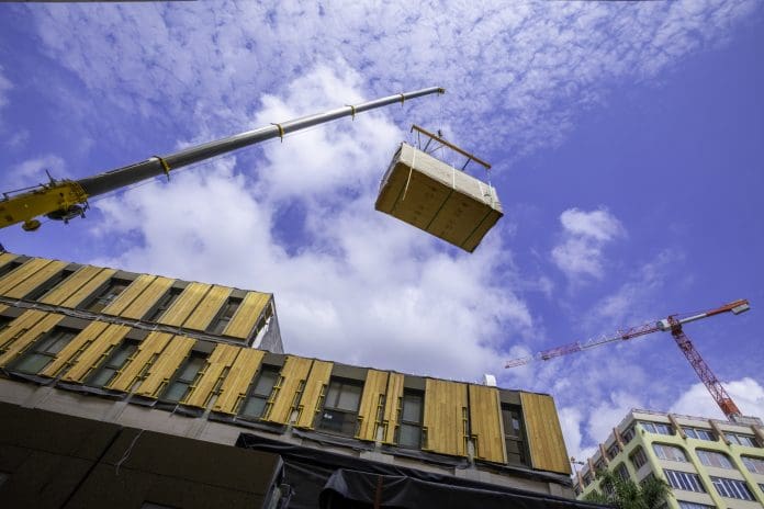 Pre-fabricated modular wood commercial building being assembled with crane Ireland is on the path to leading offsite and other Modern Methods of Construction in Europe, says Paul Tierney, CEO of MMC Ireland
