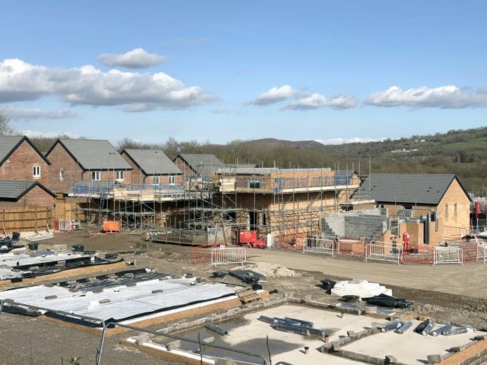 Pontypridd, Wales - April 2023: House foundations and unfinished detached houses on a new housing development in Church Village near Pontypridd. the developer in Bellway Homes.