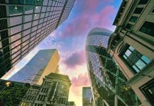 Why securing a building warranty before construction is important City of London office buildings at dawn