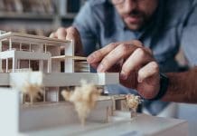 Upholding excellence: The Architects Code of Conduct & Practice Close up of male architect hands making model house. Man architect working in the office.