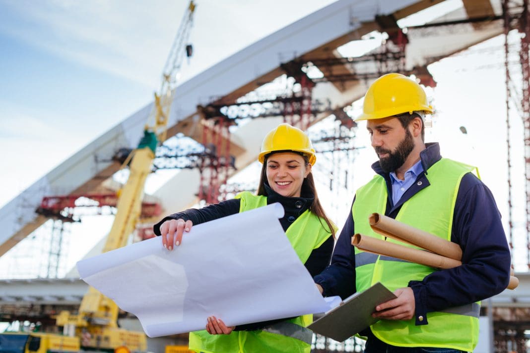 Engineers analyzing blueprint