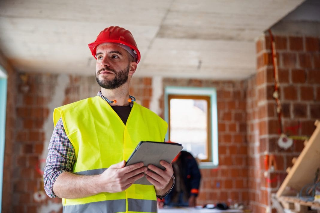 Caucasian Construction Worker Holding Digital Tablet And Looking Away According to a new survey, pro-development policy must take precedence if the construction industry is to achieve its investment potential
