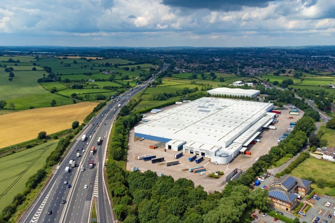 Large distribution centre next to M6 motorway, England, UK Large warehouse construction in the UK