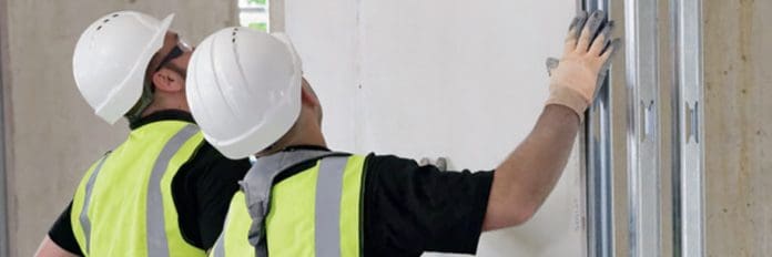 Etex renew membership with Secured by Design Workers fitting security system, like those designed by Siniat who have renewed membership with Secured by Design