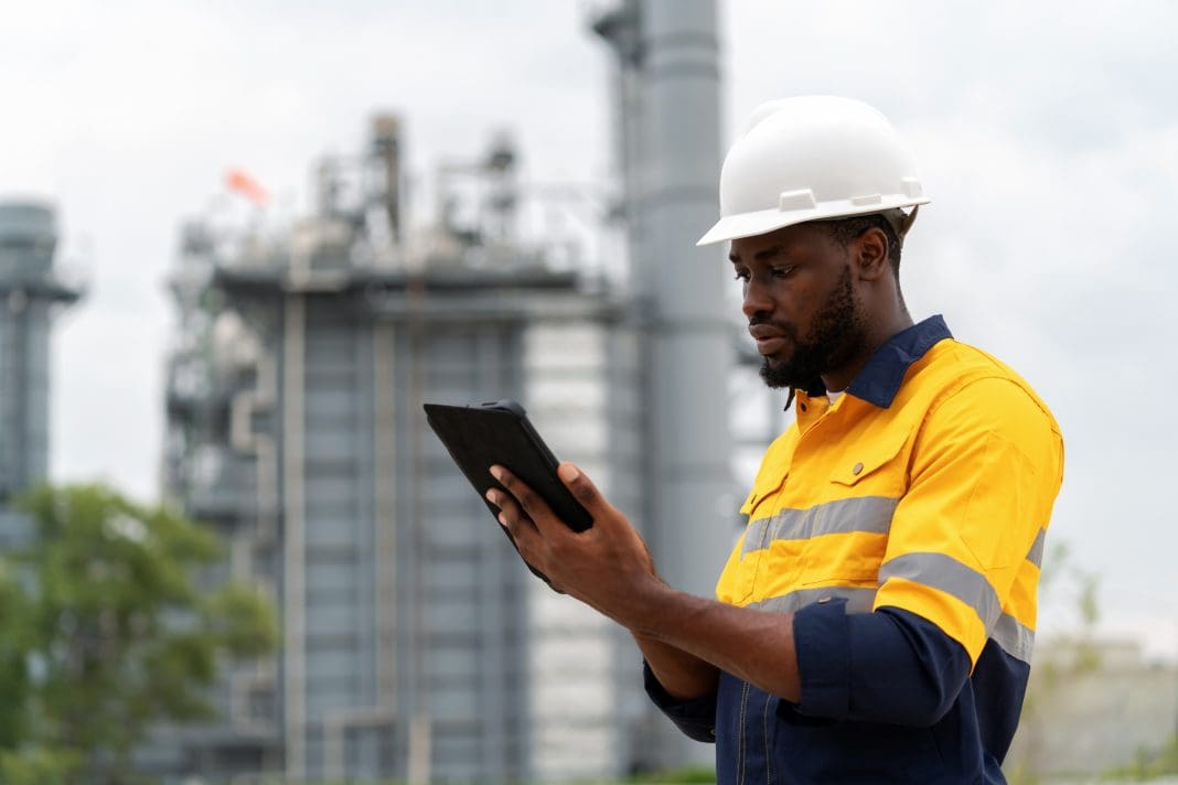 African America expert electrical engineer in safety suit and hardhat using a digital tablet to analyze plant data in the power plant factory. Ensuring the plant's efficiency and safety is paramount. Clarke Williams highlights RiskSTOP's emerging risks report, which identifies new trends as well as the most common interventions