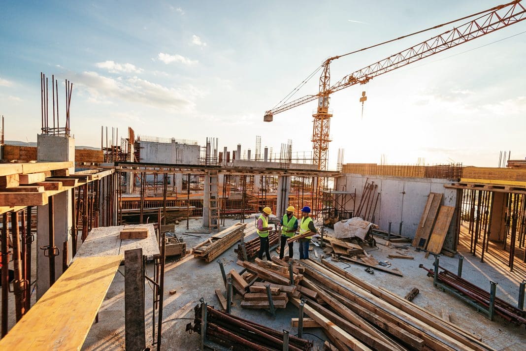Investors and contractors on construction site Construction spending is set to rise, meaning more projects