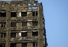 Grenfell: Systemic failures are still happening on our watch Grenfell Tower, London, a high-rise building, showing severe fire damage and broken windows against a clear blue sky after the fire of 14 June 2017.