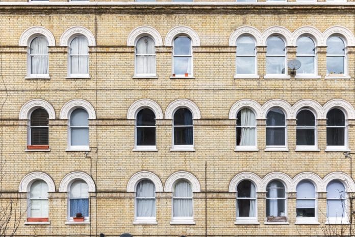 UK retrofit delivery models: Call for clarity in the face of fragmentation Georgian style apartment with arched windows around Elephant and Castle area in south London, representing retrofit models