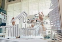 Exploring the impacts of metaverse adoption on AEC and BIM workflows Asian woman Architect or Engineer wearing VR headset for working design 3D architectural precast concrete building model with BIM technology and virtual reality technology. Concept futuristic design.