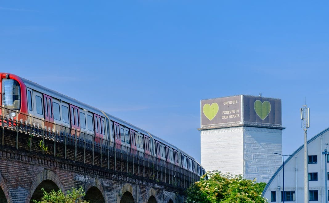 A train passes in North Kensington with the Forever in our hearts support banner visible on the Grenfell tower in the background The cladding fund was established in the aftermath of the Grenfell disaster