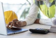 Sterling launches cost & carbon Forecasting Module to revolutionise construction planning engineer doing project calculations on laptop