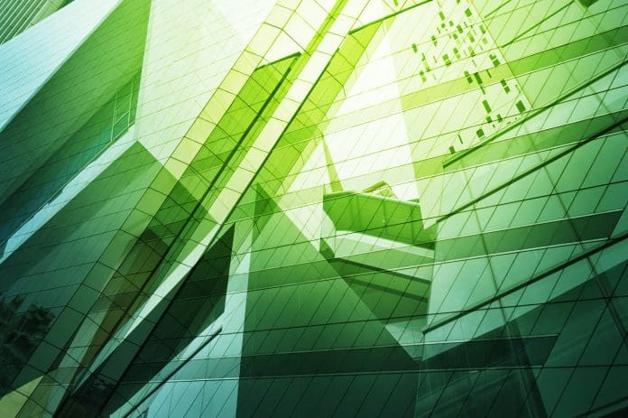 Glass of modern tower An abstract image of modern glass buildings in green light representing #GreenSkillsAtCOP