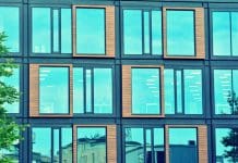 How to design climate resilient buildings using data-driven design Modern office building facade abstract fragment, shiny windows in steel structure, retro stylized colorful tonal filter effect, representing climate resilient design