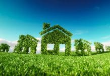 The cost of sustainability in the UK housebuilding market: Lessons from Belgium Sustainable eco village concept. 3d rendering of house symbols on fresh spring meadow with blue sky in background
