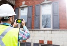 Key success factors for energy efficiency retrofitting in the tertiary building sector Home inspector using thermal camera to analyse the heat loss of a house