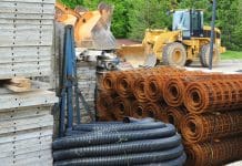 How biomaterials are redefining the concept of sustainable design Various piles of building materials (concrete, tubing, wire) at a construction site.