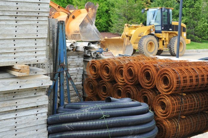 Supplies at a construction site Various piles of building materials (concrete, tubing, wire) at a construction site.