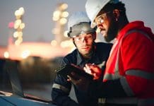 From remote to resilient: the importance of mobile solutions for field workers Team Inspection engineers working with laptop of oil factory and gas refinery plant industry at night for inspector safety quality control, representing the need for mobile field worker solutions