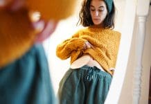 Joined-up thinking is key to taking a pan-disability approach to design reflection of a woman looking at the ostomy bag in the mirror at home. colon cancer, representing the need to take a pan-disability approach in design