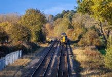Network Rail to form property company to deliver land for 40,000 homes Rural railway station Autumn Midlands UK Passenger commuter train arriving at rural country station with autumn colour surrounding it, representing the new Network Rail property company