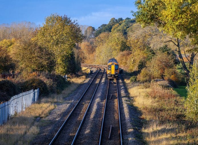 Rural railway station Autumn Midlands UK Rural railway station Autumn Midlands UK Passenger commuter train arriving at rural country station with autumn colour surrounding it, representing the new Network Rail property company