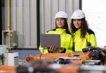 How to choose the right limit of indemnity for professional indemnity insurance Two engineers in safety gear analyze robotic arms in a modern manufacturing plant. They check configurations and ensure quality standards are met, representing professional indemnity insurance