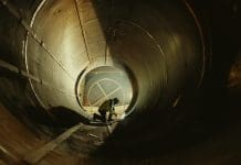 Hinkley Point C tunnellers strike called off Professional Heavy Industry Worker Wearing Helmet Welding Inside Oil and Gas Pipe. Construction of the Oil, Natural Gas and Biofuels Transport Pipeline. Industrial Manufacturing Factory, representing hinkley point c strike