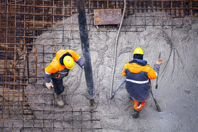 Workers pouring concrete. Concrete pouring on the construction site