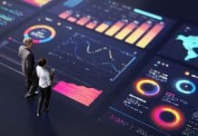 The benefits of data driven construction procurement Abstract people standing on a large digital screen, analysing interactive data visualisations and charts for strategic planning. Representing teamwork, technology, and data-driven decision making in a corporate environment.