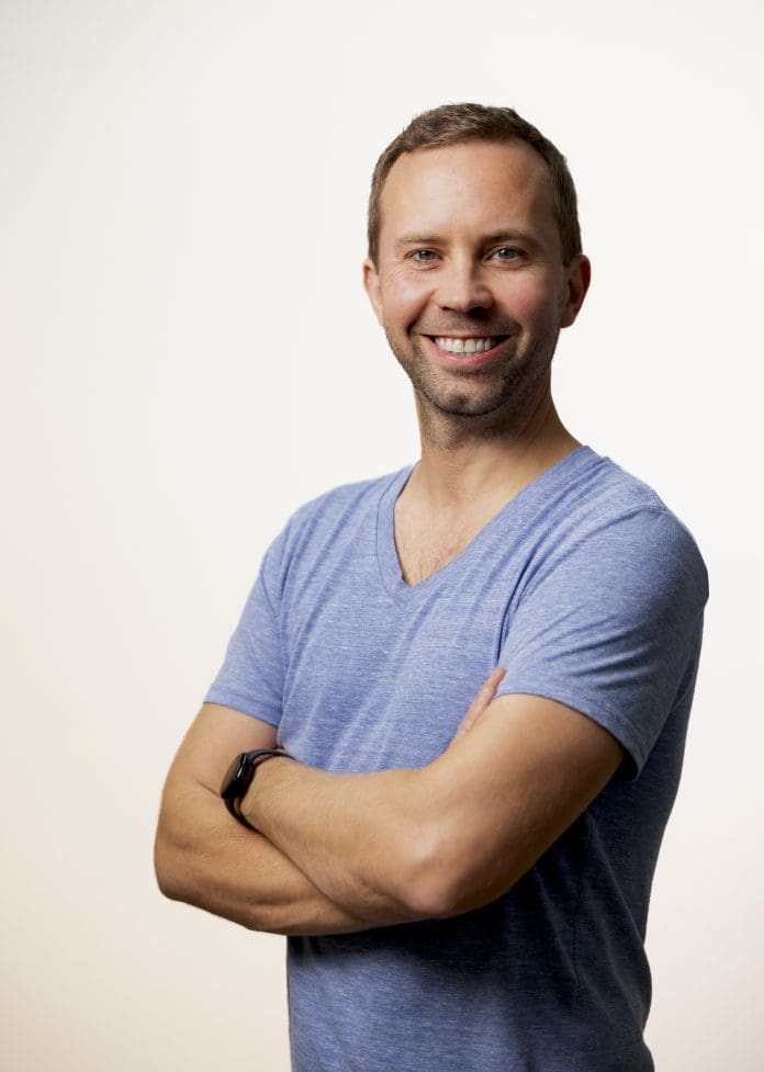 Andreas Mjelde, co-founder and CEO of Two, standing against a white background, arms folded, looking towards the camera