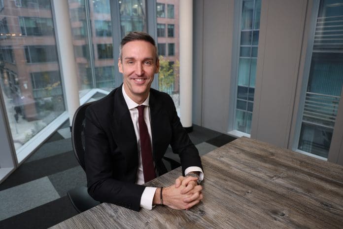 Robbie Blackhurst, chair of the Centre for Construction Best Practice, sits at a desk looking up towards the camera