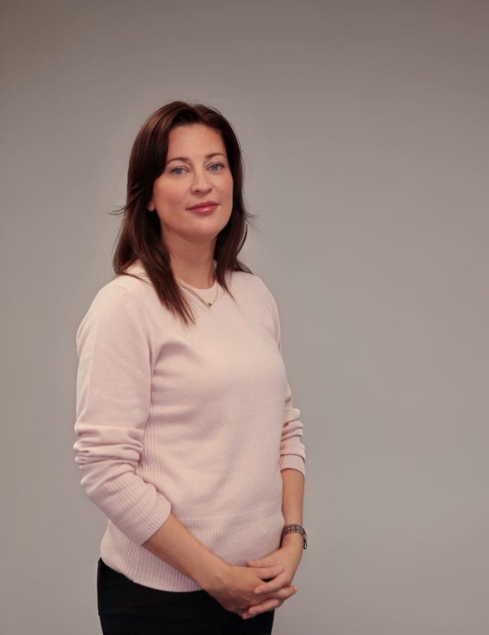 Headshot of Catherine Storer of Essential Site Skills looking towards the camera against a grey background