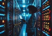 Data centre boom: Assessing supply chain strains amid unprecedented demand A female IT worker stands amid data centre racks in silouhette, representing data centres